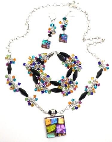 Dichroic glass with Austrian crystal and sterling silver. Necklace, earrings and bracelet.