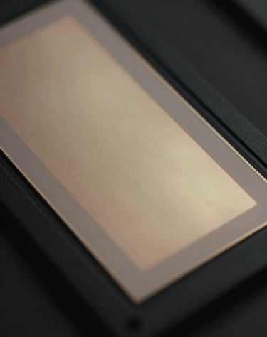 Artistic close-up of a digital film sensor with muted champagne gold light flares, premium cinematic texture, deep obsidian black background.