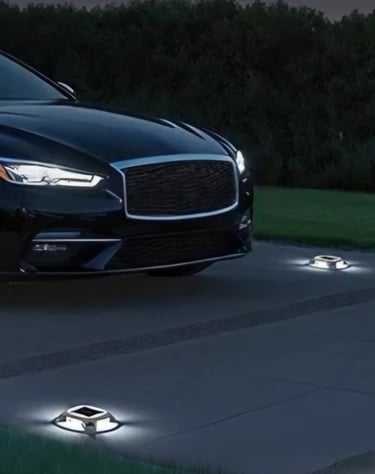 A black luxury sedan parked on a driveway illuminated by solar powered LED deck and dock lights.