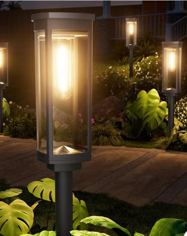 outdoor pathway lights illuminating a garden walkway at night.