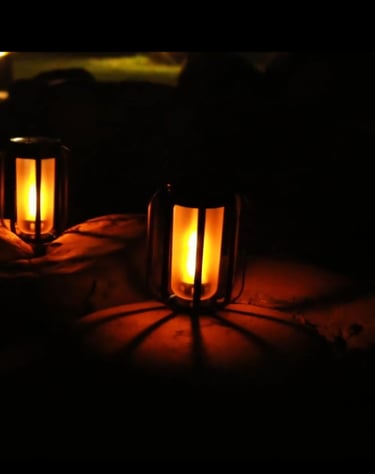 brightly glowing lanterns lighting up dark yard.