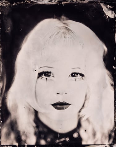 Wetplate Vintage-style sepia portrait of a woman with dramatic goth style makeup and dark lipstick