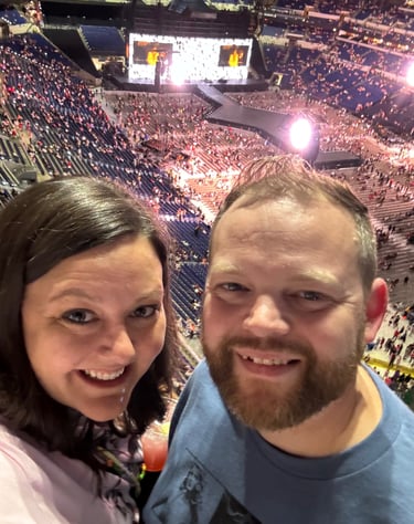 A husband and wife smiling at a Taylor Swift concert