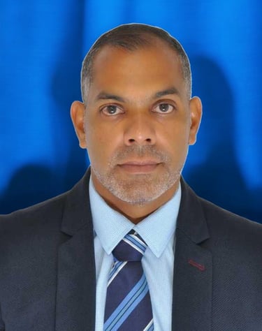 a man in a suit and tie with a blue background