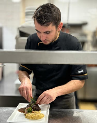a man in a chef's uniform preparing food