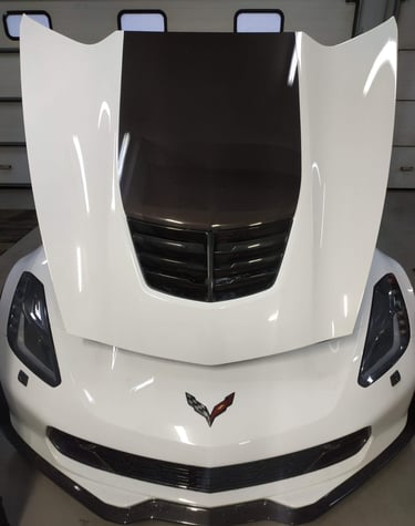 an Enlab white corvette corvette with a black hood
