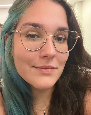 a woman with blue hair and glasses on her face