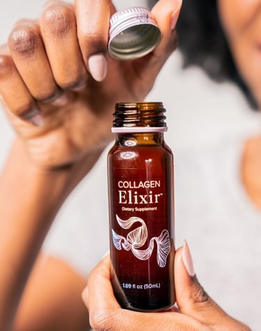 a woman holding a bottle of elixix elixixix