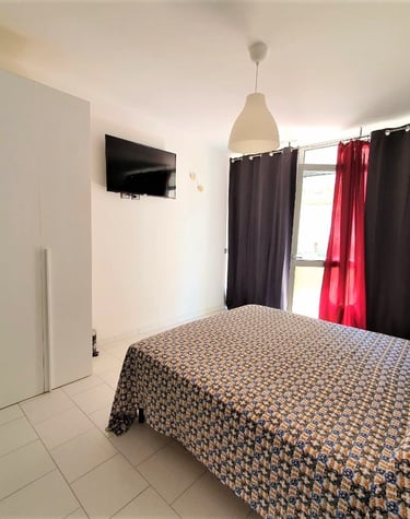 a bedroom with a bed and a television