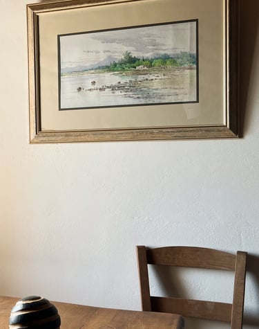 a table with three candles and a picture of a window