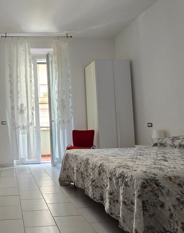 a bedroom with a bed and a television