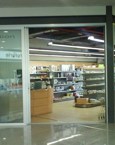 Corredera 3 hojas de entrada a establecimiento de alimentación.