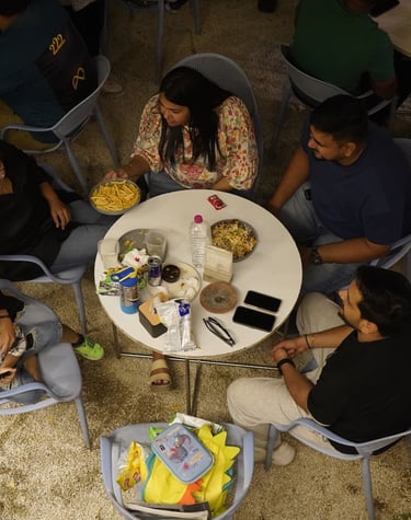 a group of people sitting around a table at basil the otherside