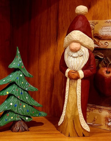 Hand  Santa in robe and hat beside a decorated xmas tree,.  Carved by James Smith
