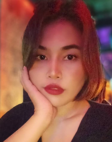 Lady with black top and one hand on face