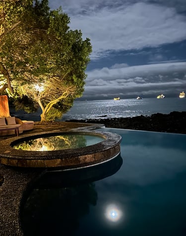Outdoor pool area at Villa Escalesia Galapagos, offering a relaxation space within a refi