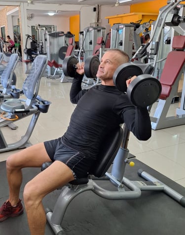 Man lifting dumbells  in a gym in Pattaya