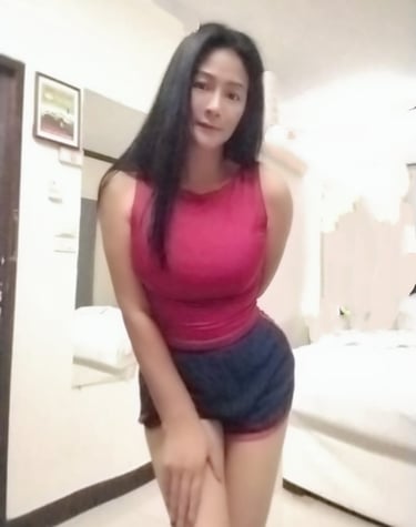 a lady standing slightly bent forward with one hand on her leg