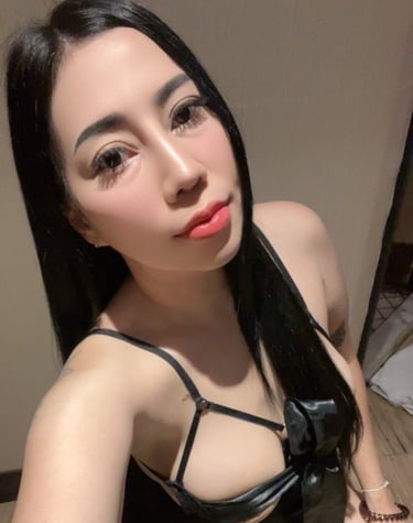 Lady wearing a black under garment and poised on her knees