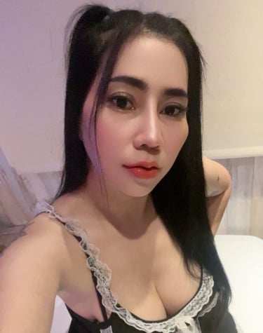 Lady wearing a black and white under garment and poised on her knees