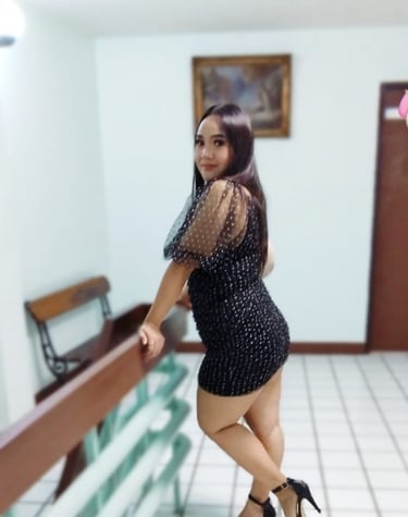 full length photo of lady posing sideways holding a hand rail 
