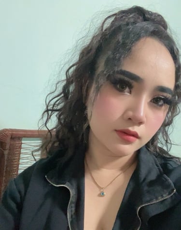 half body shot of lady with black hair wearing a black dress with zip