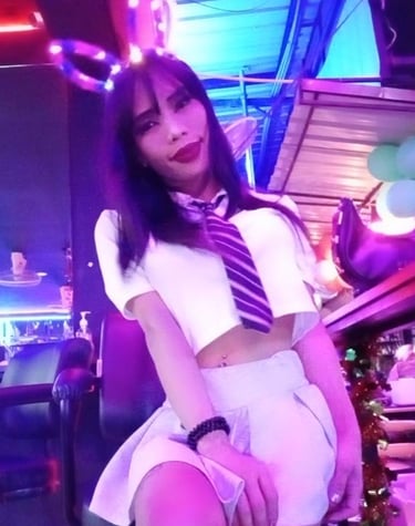 ladyboy wearing a schoolgirl uniform with tie