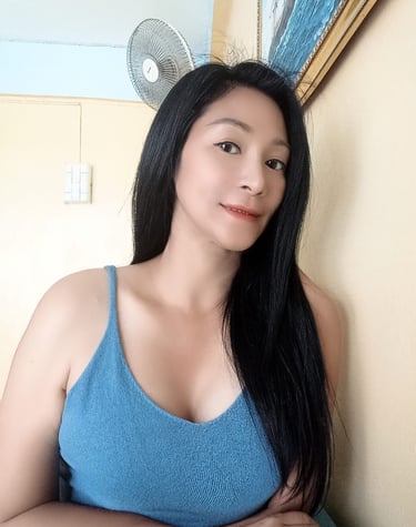 half body photo of a lady with long black hair and a blue crop top