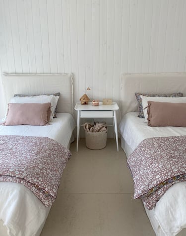 two beds in a room with white walls and white walls