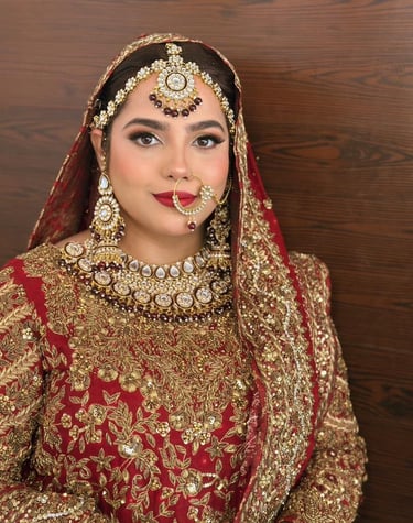 a bride in a red and gold bridall, best makeup artist in dubai , bridal makeup Dubai best