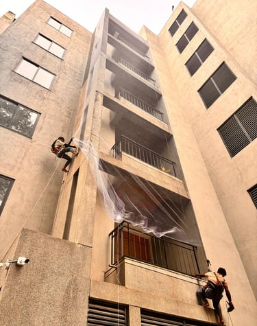 Bright morning view of a Whitefield apartment complex featuring clean, white safety nets protecting 