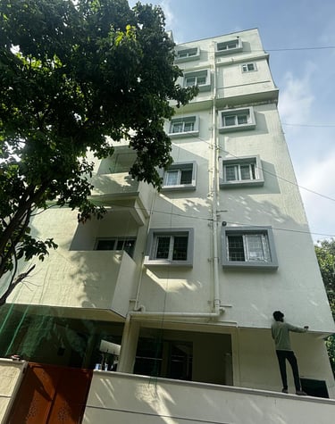 Brightly lit evening shot of safety nets glowing softly on a high-rise facade.
