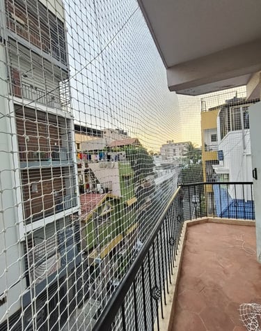 Modern balcony with elegantly arranged pigeon nets designs by Arjilli Enterprises in Bangalore.