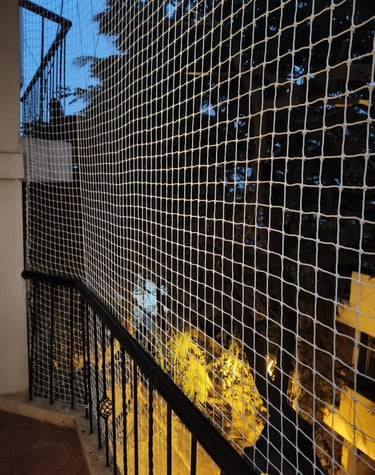 Close-up of a securely installed balcony safety net on a high-rise apartment in Vijayawada.