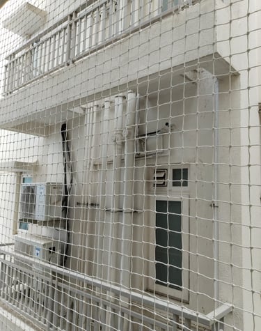 Close-up of a securely installed balcony safety net in a modern apartment in Anna Nagar.