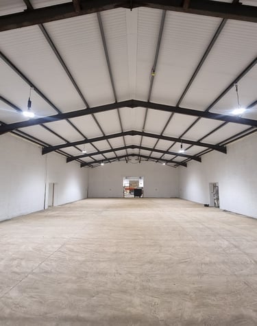 A large, open interior of a warehouse painted white.