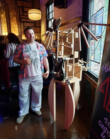 Frank con esculktura de reciclado de madera y guitarra