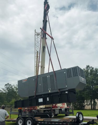 Techs using a crane to lift a 500kw standby industrial generac generator