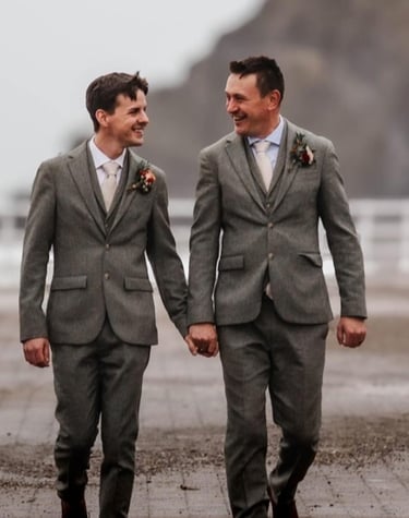 a couple of men in suits walking down a path