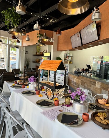 A table setting with Chai and Indian Desserts and Treats