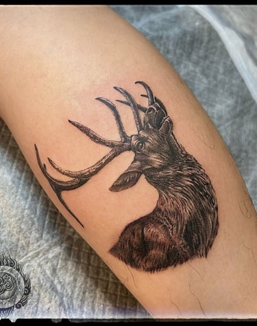 Realistic tattoo of a healthy elk on the forearm