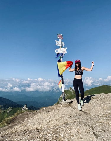 a woman standing on top of a mountain