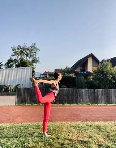a woman in a red sports bra top doing yoga