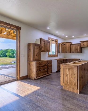 custom wood floors and cabinets in kitchen by Saddle Horn Custom Homes