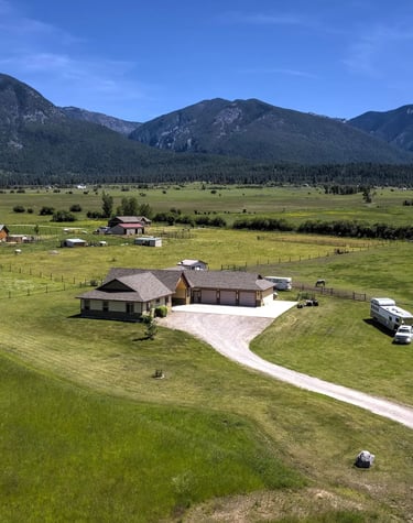 Aerial view of custom home with Montana's Mission Mountains in the background by Saddlle Horn