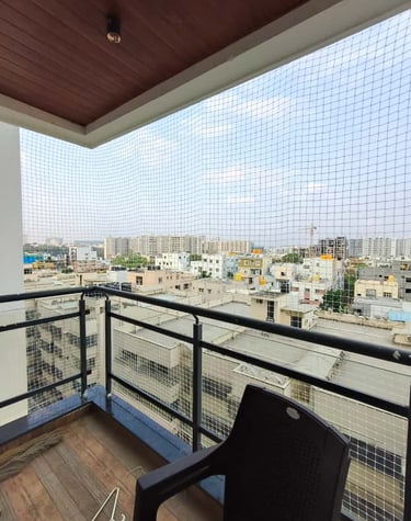 Close-up of a tightly woven pigeon net installed on a balcony in Bangalore.