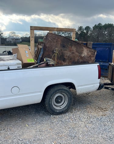 a truck with a large pile of junk in the back of it