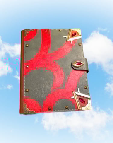 Handmade leather fantasy spellbook with red velvet patterns and ruby crystals floating in a blue sky.