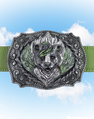 Ornate silver skunk head belt buckle on a green strap with a blue sky background.