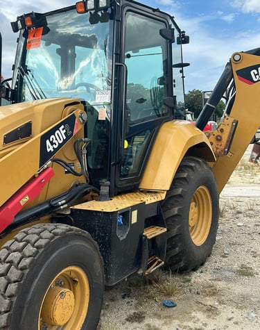 a yellow backhoeck tractor with a large wheel